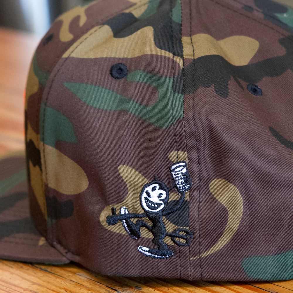 Close up of camo embroidered Fall Brewing Company hat